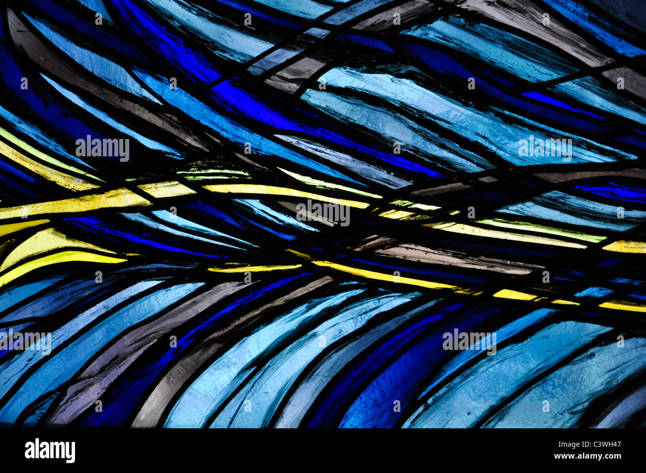 blue lead glass window with a yellow wave structure Stock Photo