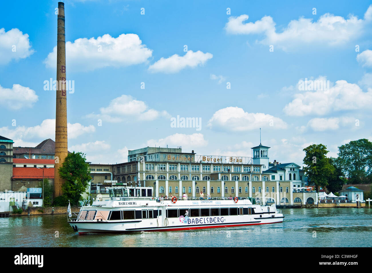 Tourist boat on River Spree in front of Berliner Buerger Braeu, Friedrichshagen, Berlin, Germany Stock Photo