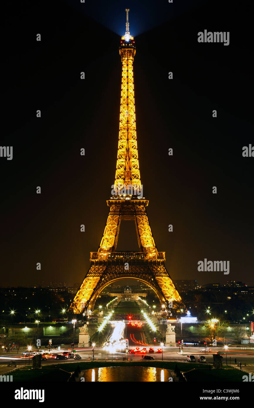 Eiffel Tower brightly illuminated at dusk in Paris. Stock Photo