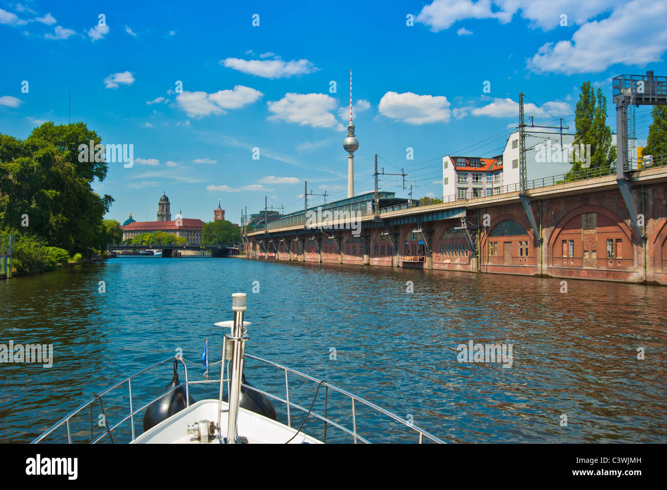 Bow of yacht on Spree river in Berlin at Jannowitzbruecke with alex tv tower in background Stock Photo