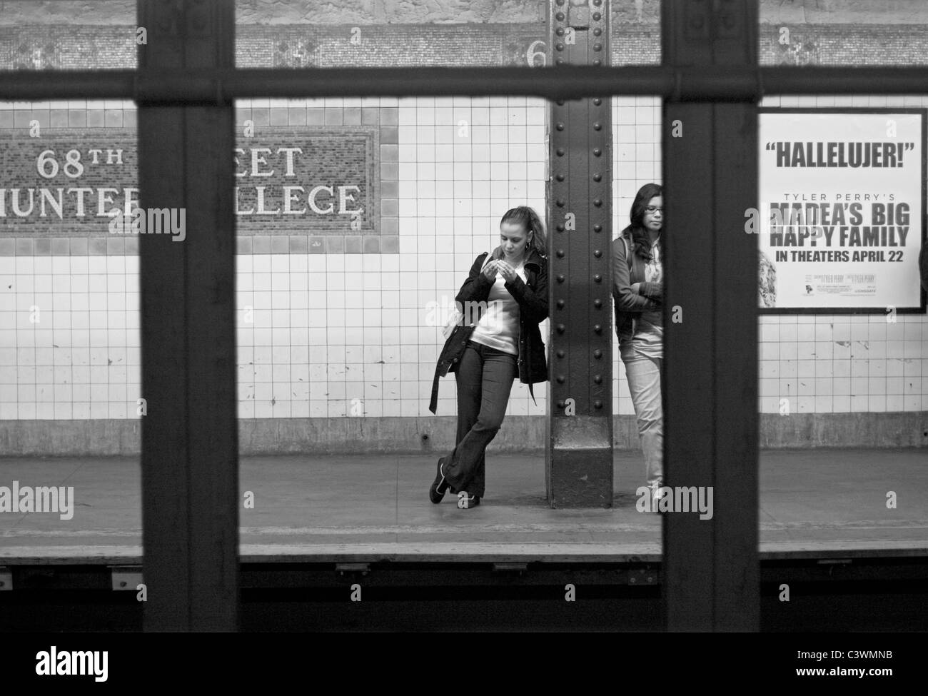 Two women wait for the subway in New York City. Stock Photo