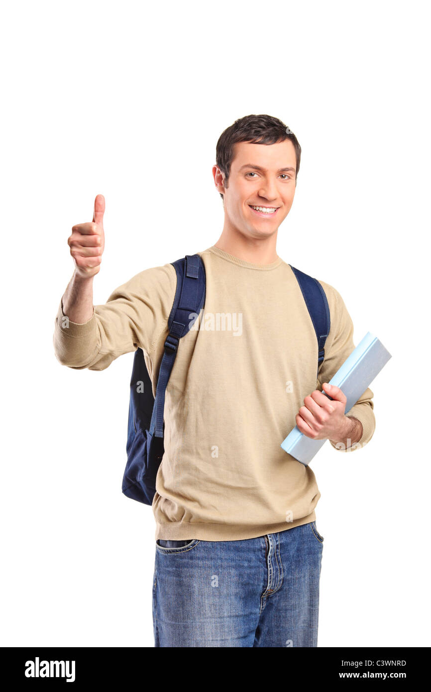 A smiling male student holding a book and giving thumb up Stock Photo ...