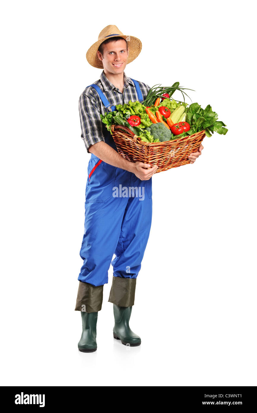 Full length portrait of a farmer holding a basket of vegetables Stock ...