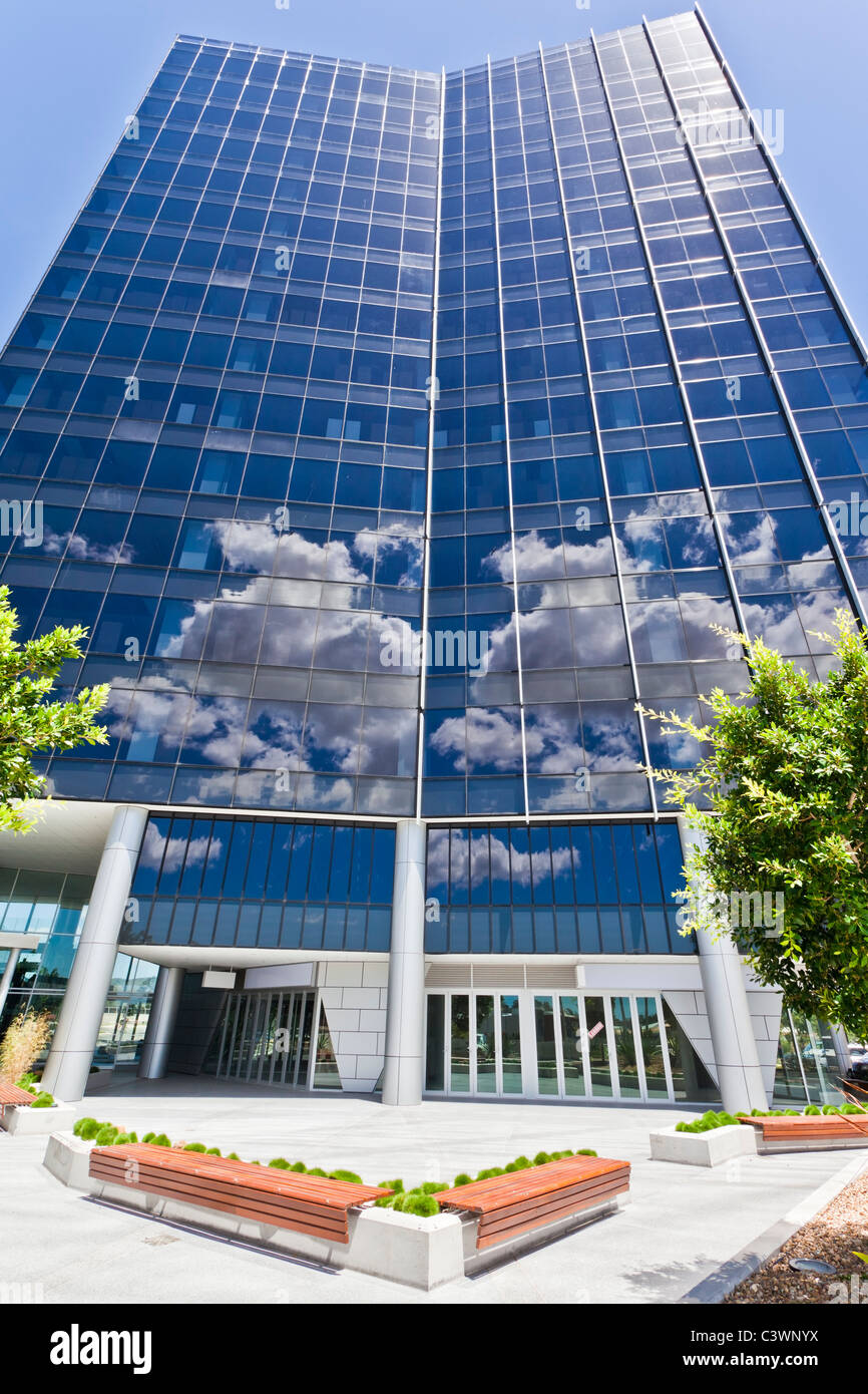 Modern Corporate Building with sky and clouds reflecting Stock Photo