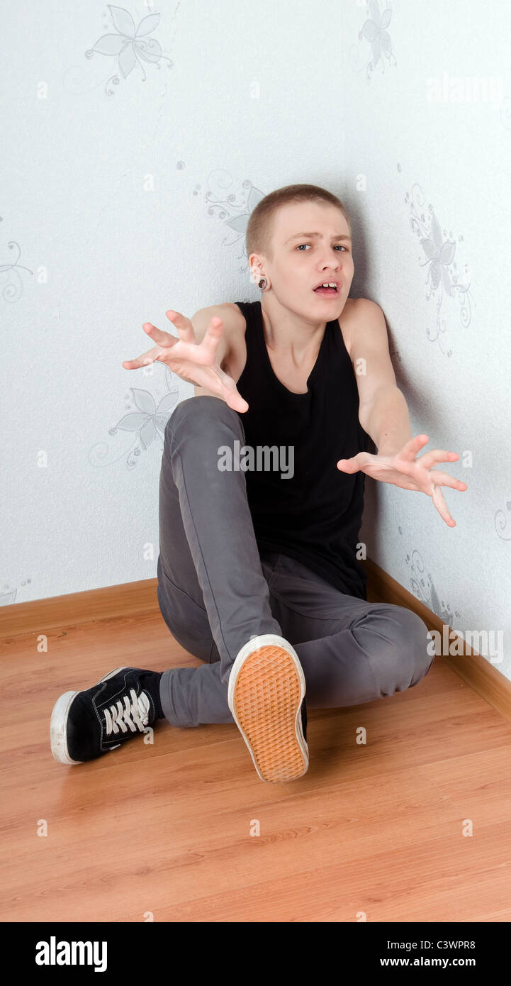 Teen afraid to sit in the corner Stock Photo