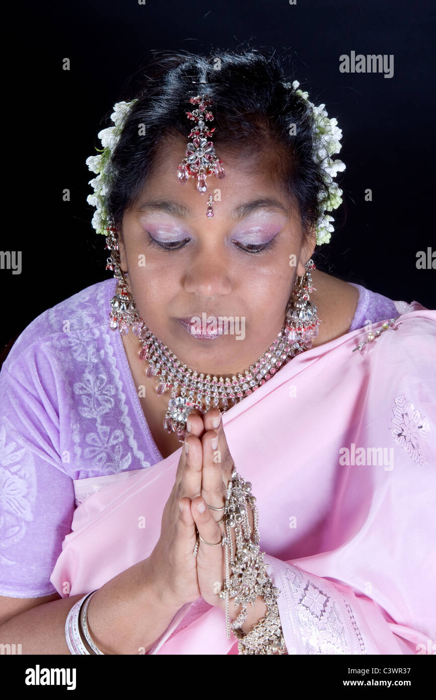 Lovely Indian woman holding her hands in prayer Stock Photo