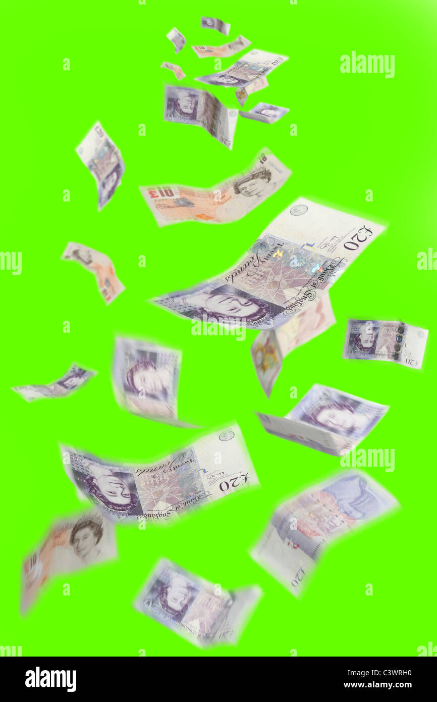 Money floating from above, British Pounds Stirling on a green background. Stock Photo