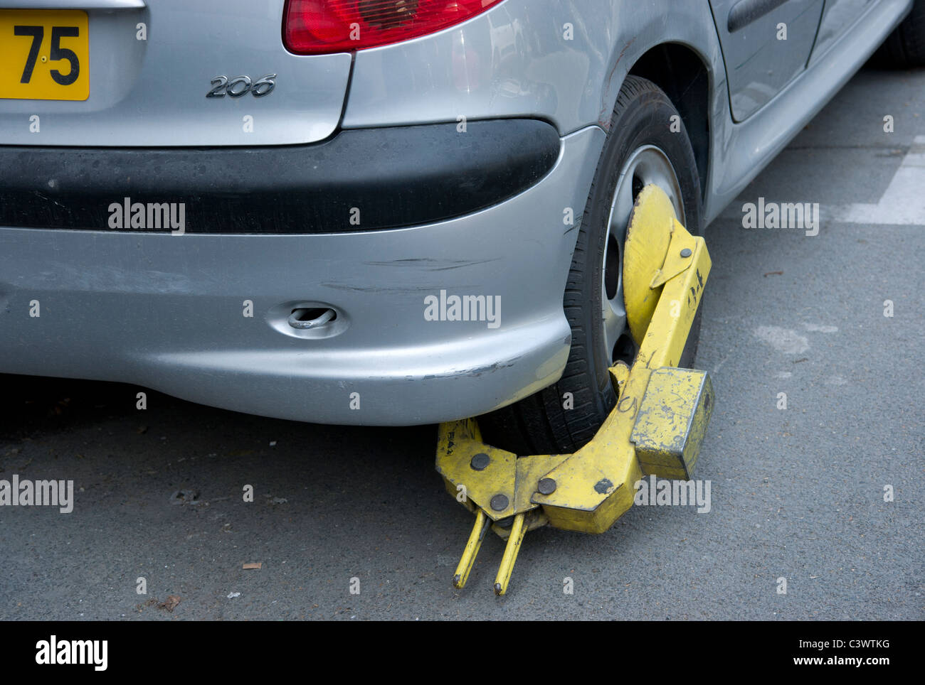 Parisian car showing 75 plate number, clamped in Paris, France Stock Photo
