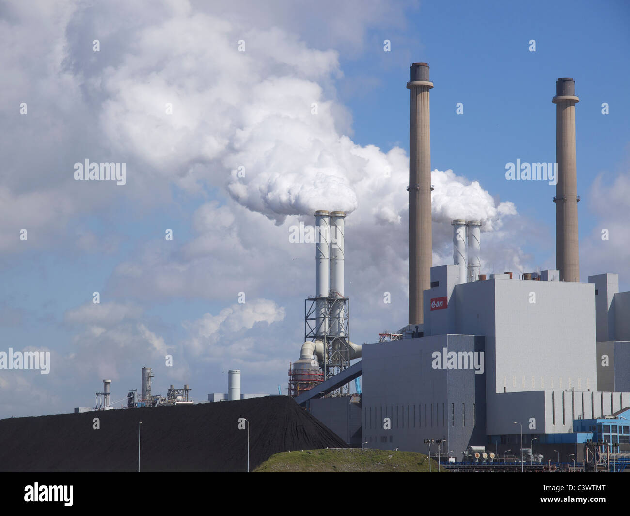 E-on powerplant on the Maasvlakte in the Port of Rotterdam, with huge pile of coal next to it. Rotterdam Netherlands Stock Photo