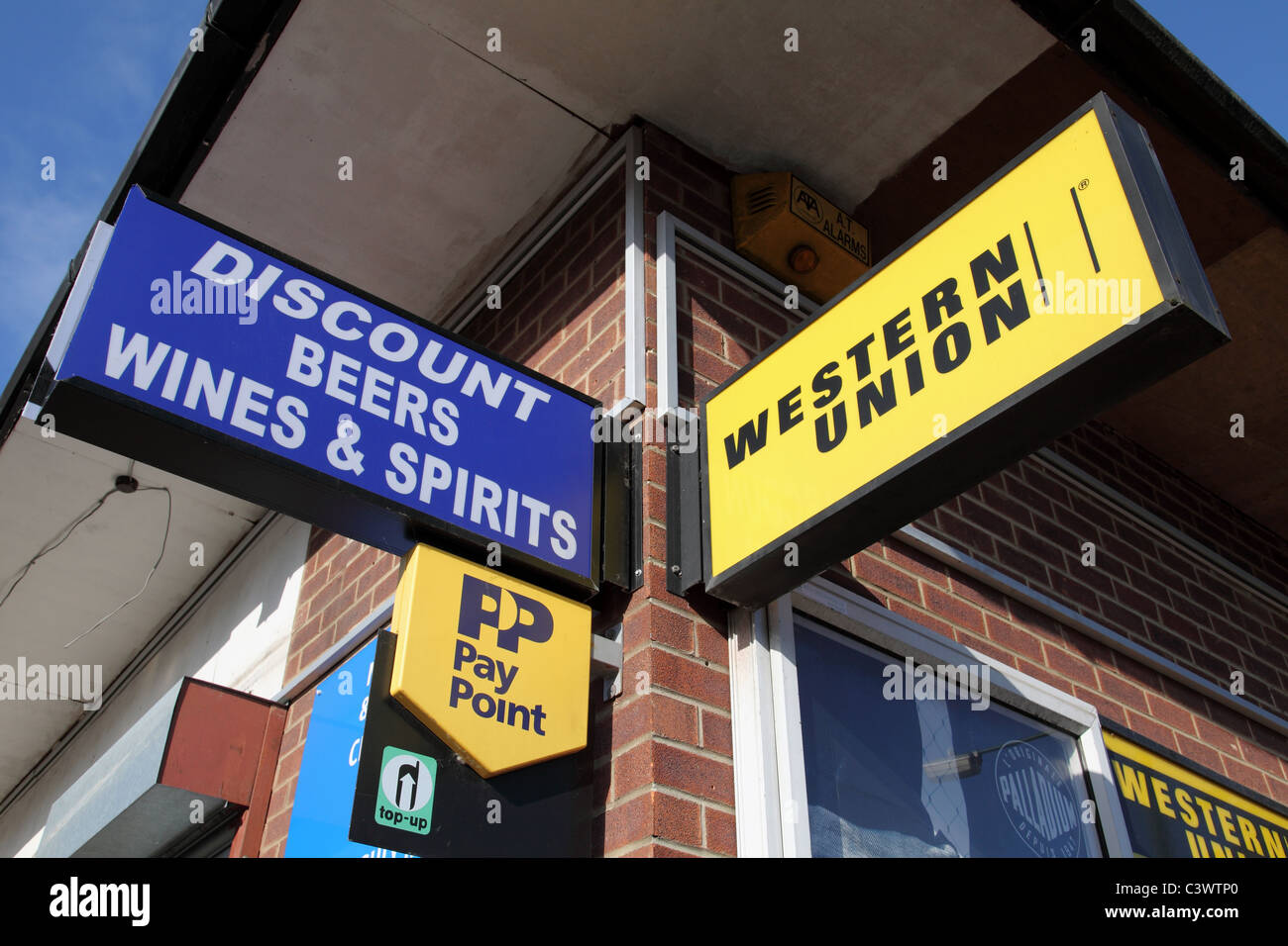 Signs on a convenience store in a U.K. city. Stock Photo