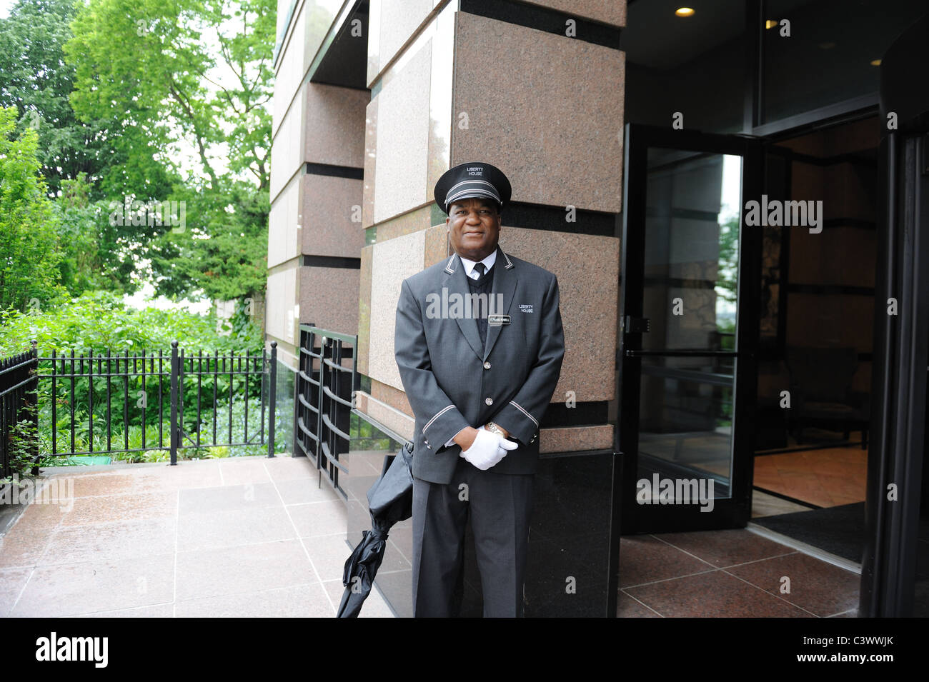 A doorman standing watch in a Manhattan apartment building Stock Photo