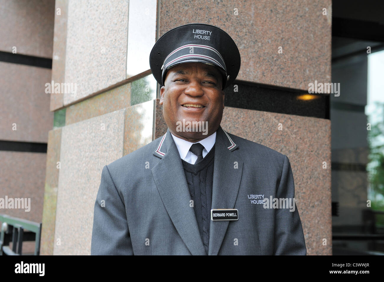 A doorman standing watch in a Manhattan apartment building Stock Photo