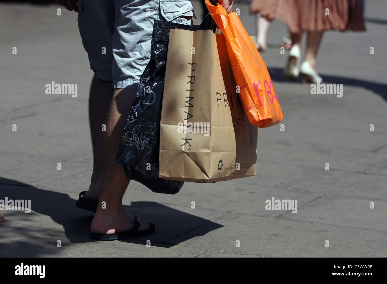 Several shopping bags being carried in london Stock Photo Alamy