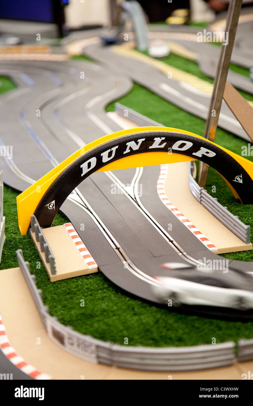 A large toy scalextric track with model cars going round the electric circuit England UK Stock Photo