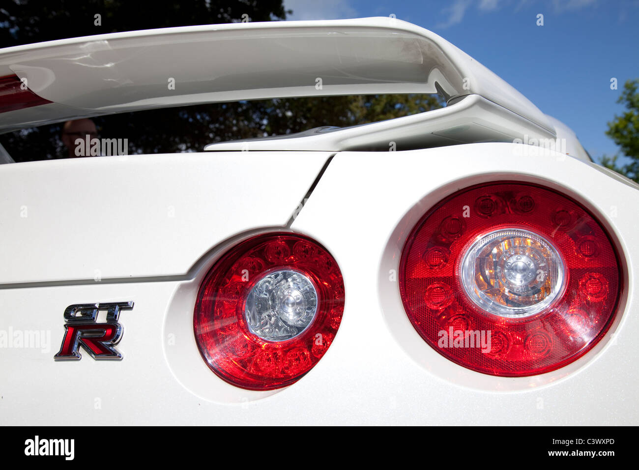 The rear brake light assembly cluster on the rear of a white Nissan GTR