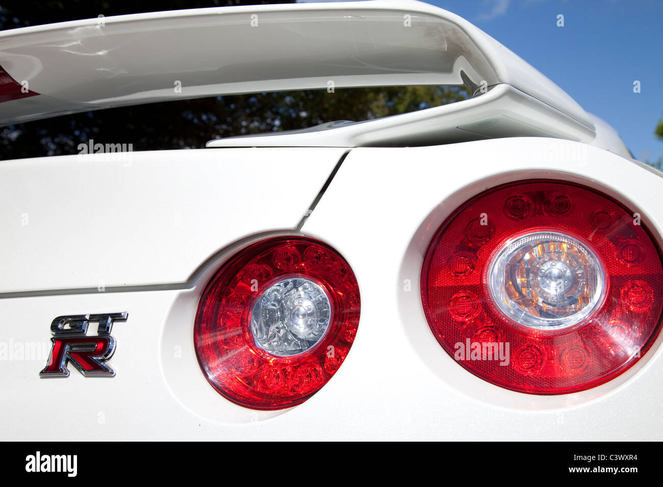 The rear brake light assembly cluster on the rear of a white Nissan GTR