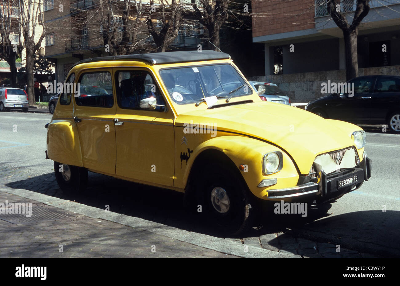 A yellow Citroën Dyane in the EUR district of Rome, Italy Stock Photo