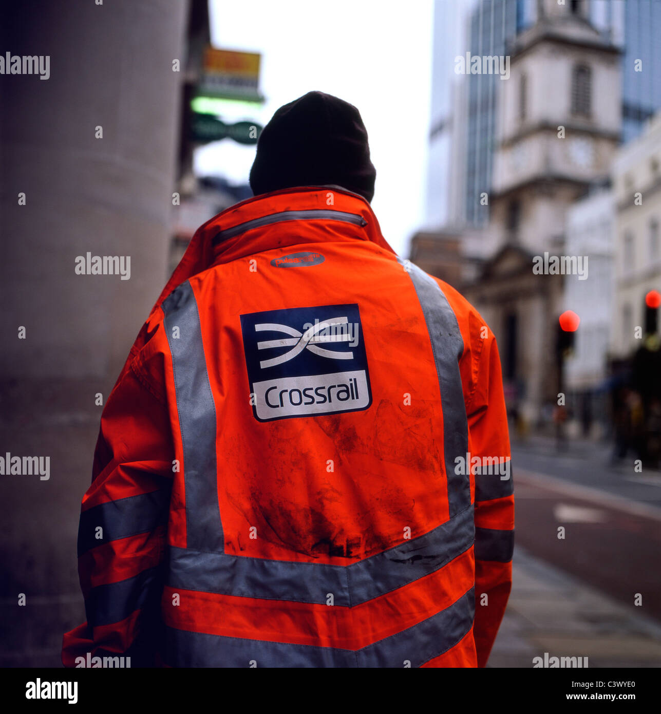 Back view a Crossrail logo on an underground worker jacket working along Bishopsgate Street in the City of London UK   KATHY DEWITT Stock Photo
