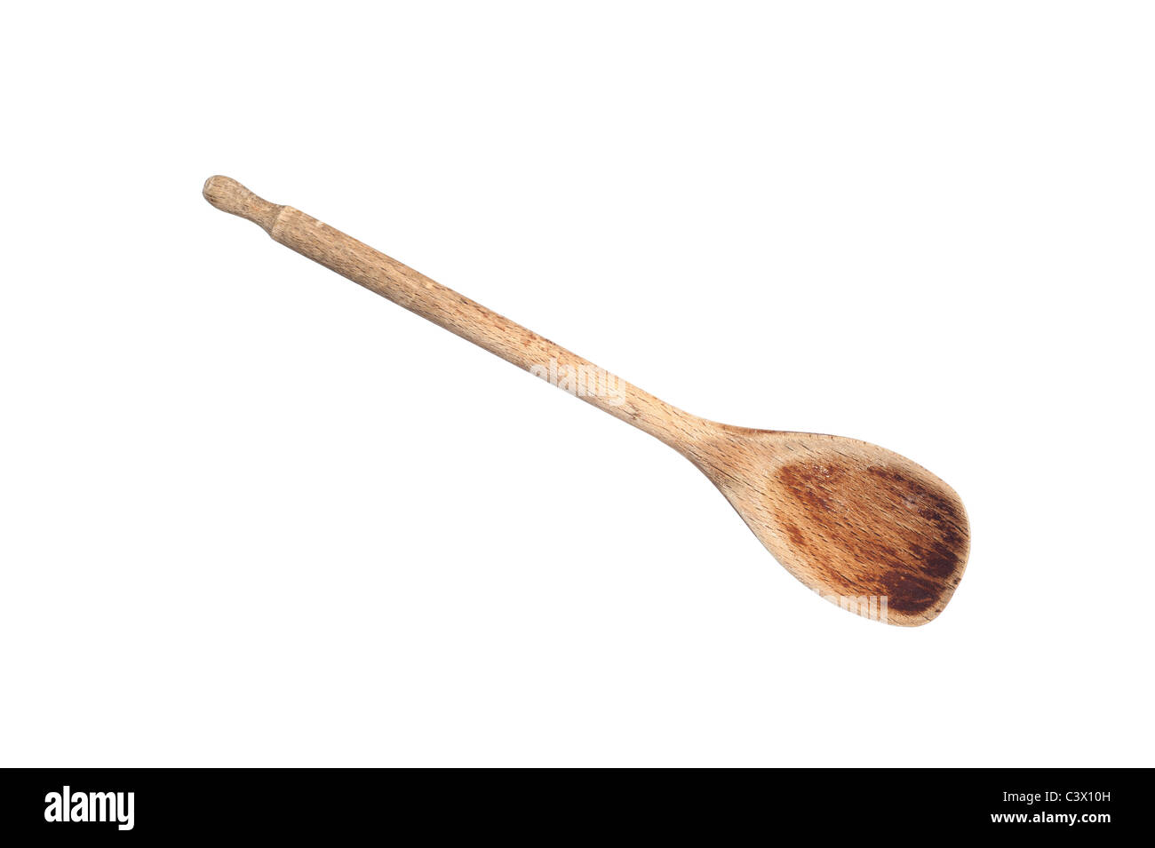 An old wooden cooking spoon isolated on white Stock Photo