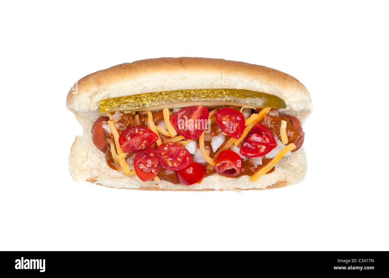 A fully loaded New Your style hotdog with pickles, onions, cheese, chili and tomato slices isolated on white Stock Photo
