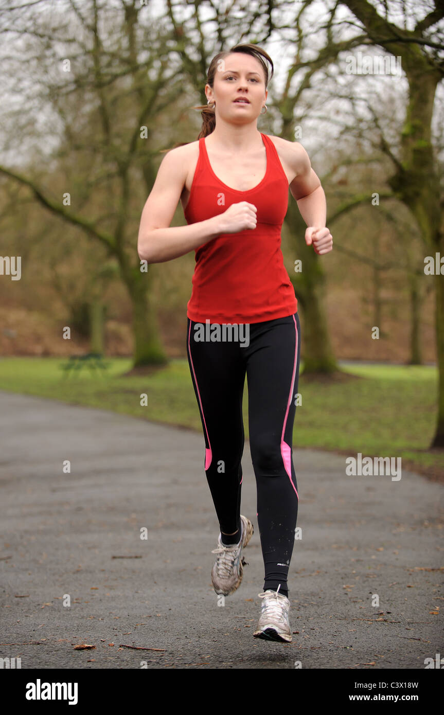 Female jogger in park Stock Photo Alamy