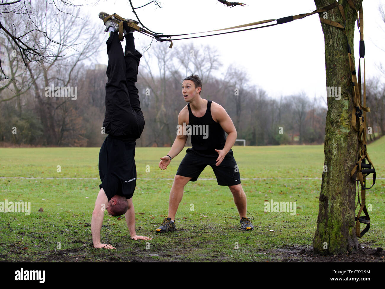 man working out in fitness boot camp with instructor Stock Photo - Alamy