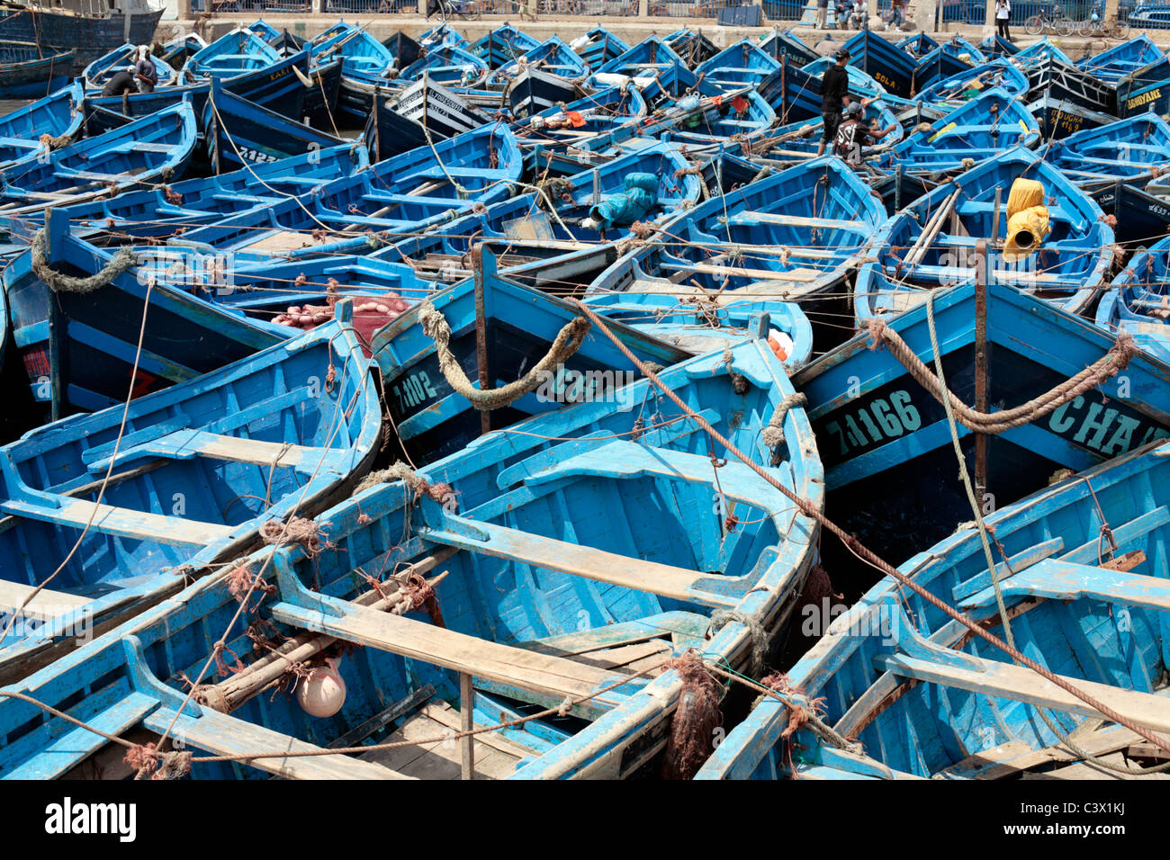 Fishing nets and blue fishing boats in Essaouira Port