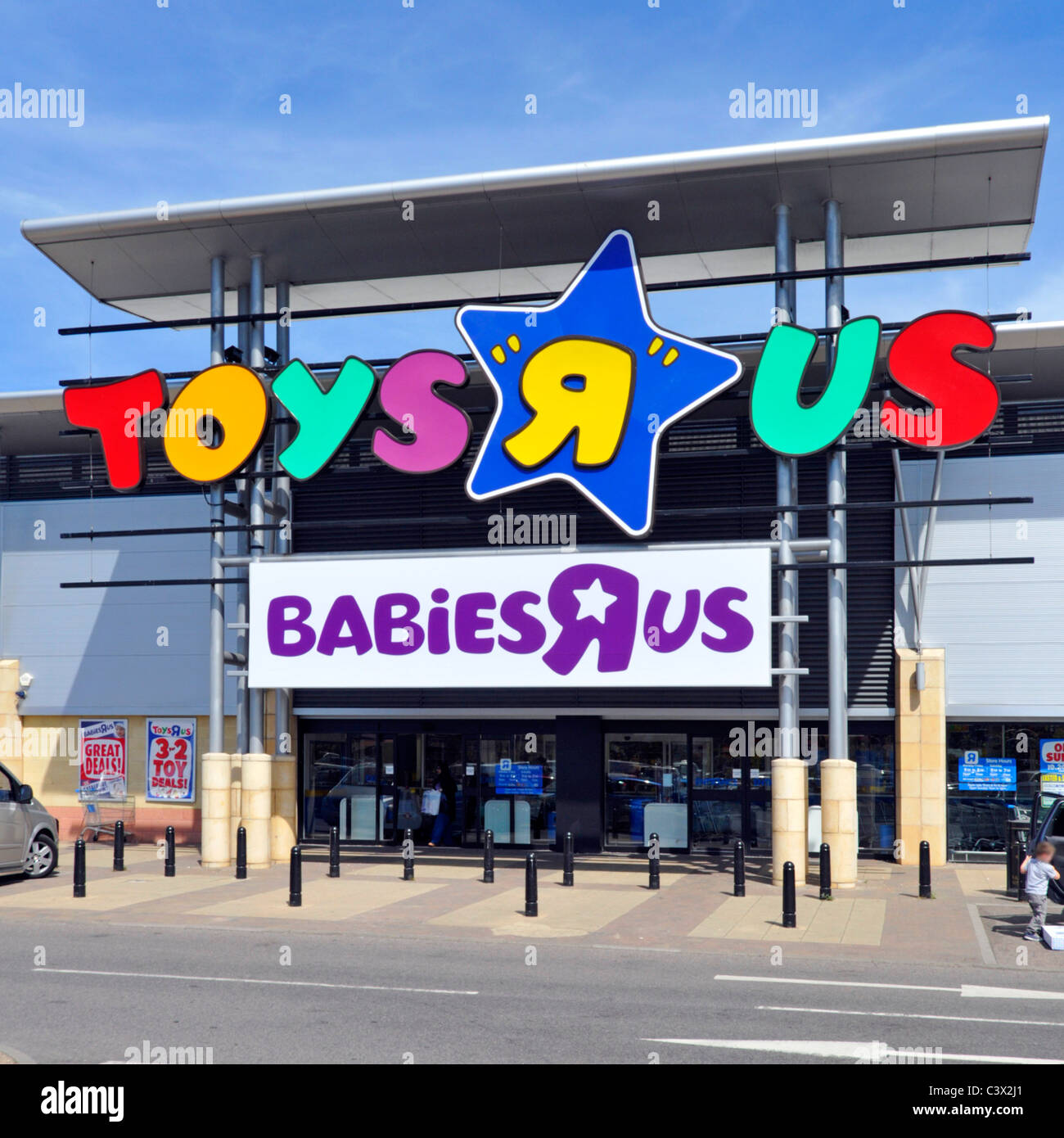 Entrance to Toys Are Us and baby store Babies R Us brand signs & logos on large shopping retail park West Thurrock Essex England UK Stock Photo