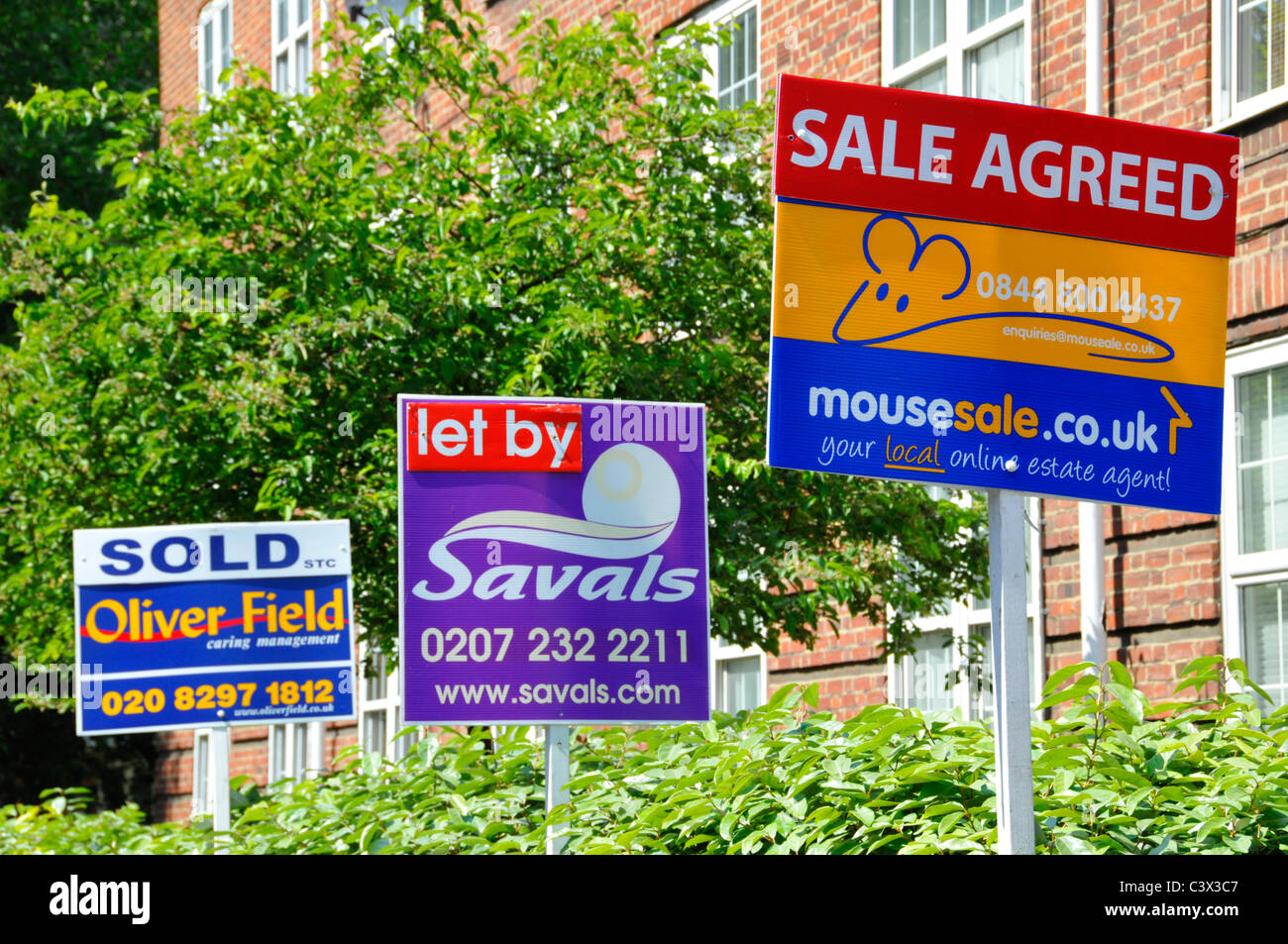 Selection of Estate Agents advertising boards for house transaction where various property has been sold let or sale agreed South London England UK Stock Photo