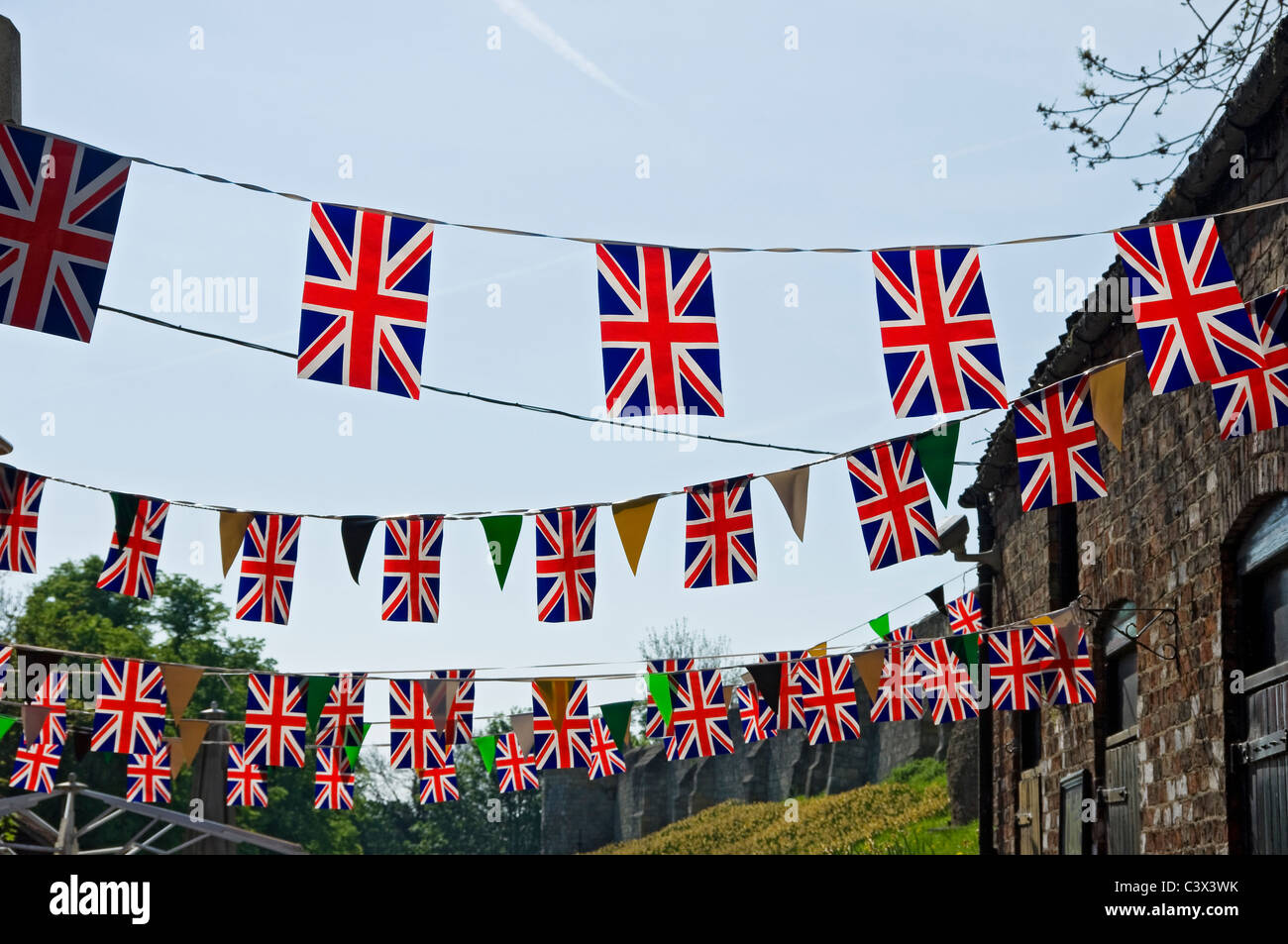 Union Jack flags flag bunting against blue sky England UK United