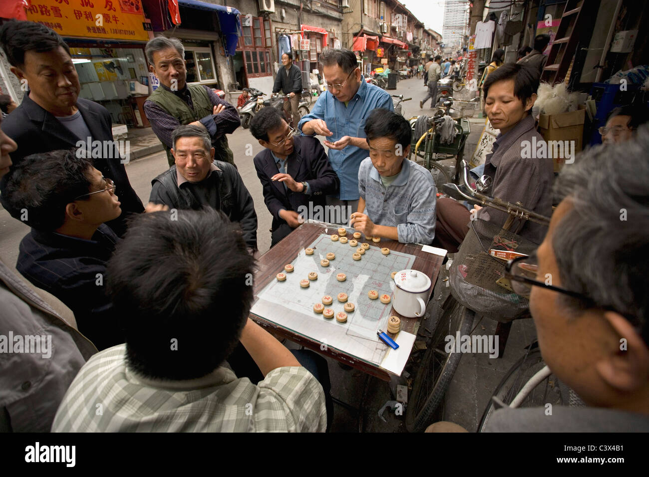 China, Shanghai, Street scenes in old city. Playing game. Stock Photo