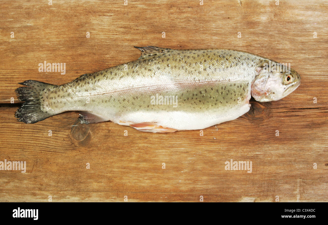 Whole fresh rainbow trout on old weathered wood Stock Photo