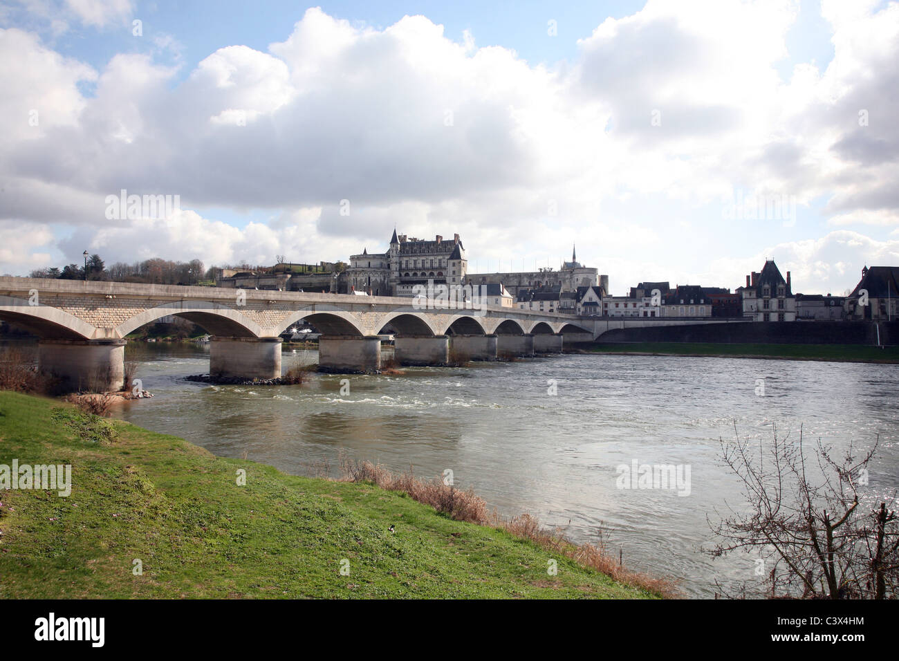 Chateau d'Amboise overlooks the stone arched bridge which spans the Loire River at the small market town of Amboise Stock Photo