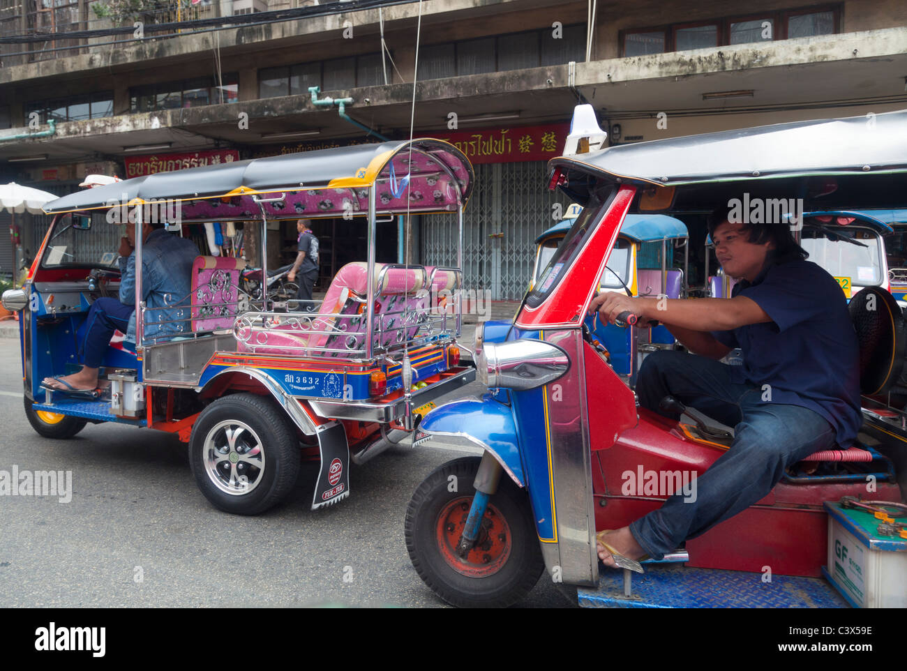 Racing tuk-tuks on the streets of Bangkok, Thailand Stock Photo