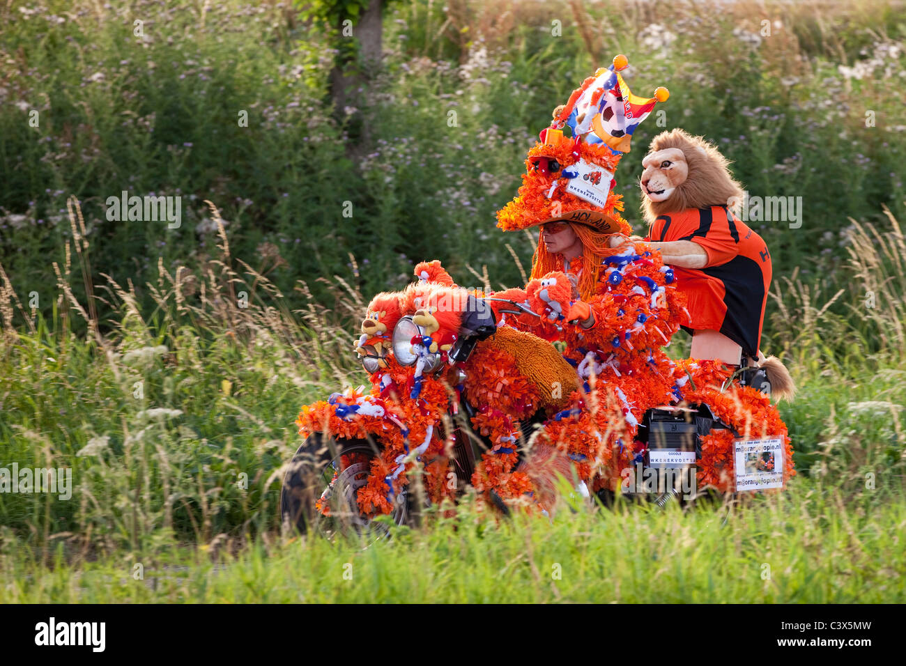 The Netherlands, World Cup Football July 2010. Motorcyclist decorated in orange, Oranje Jopie, supporter Dutch national team. Stock Photo