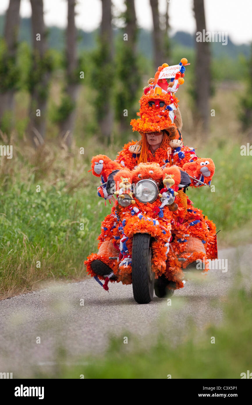 The Netherlands, World Cup Football July 2010. Motorcyclist decorated in orange, Oranje Jopie, supporter Dutch national team. Stock Photo