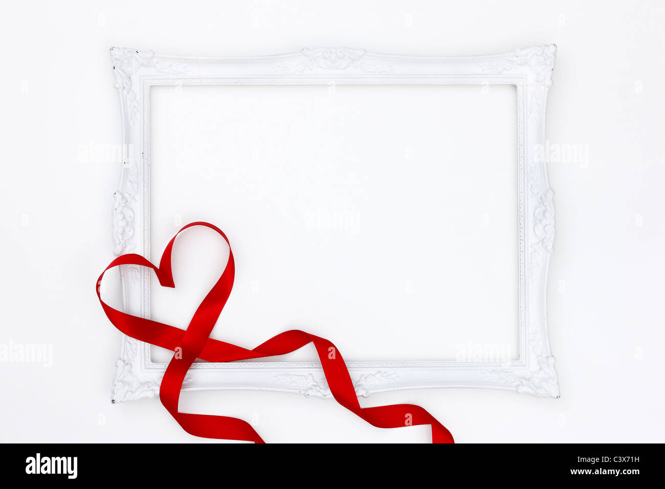 White picture frame and red ribbon Stock Photo