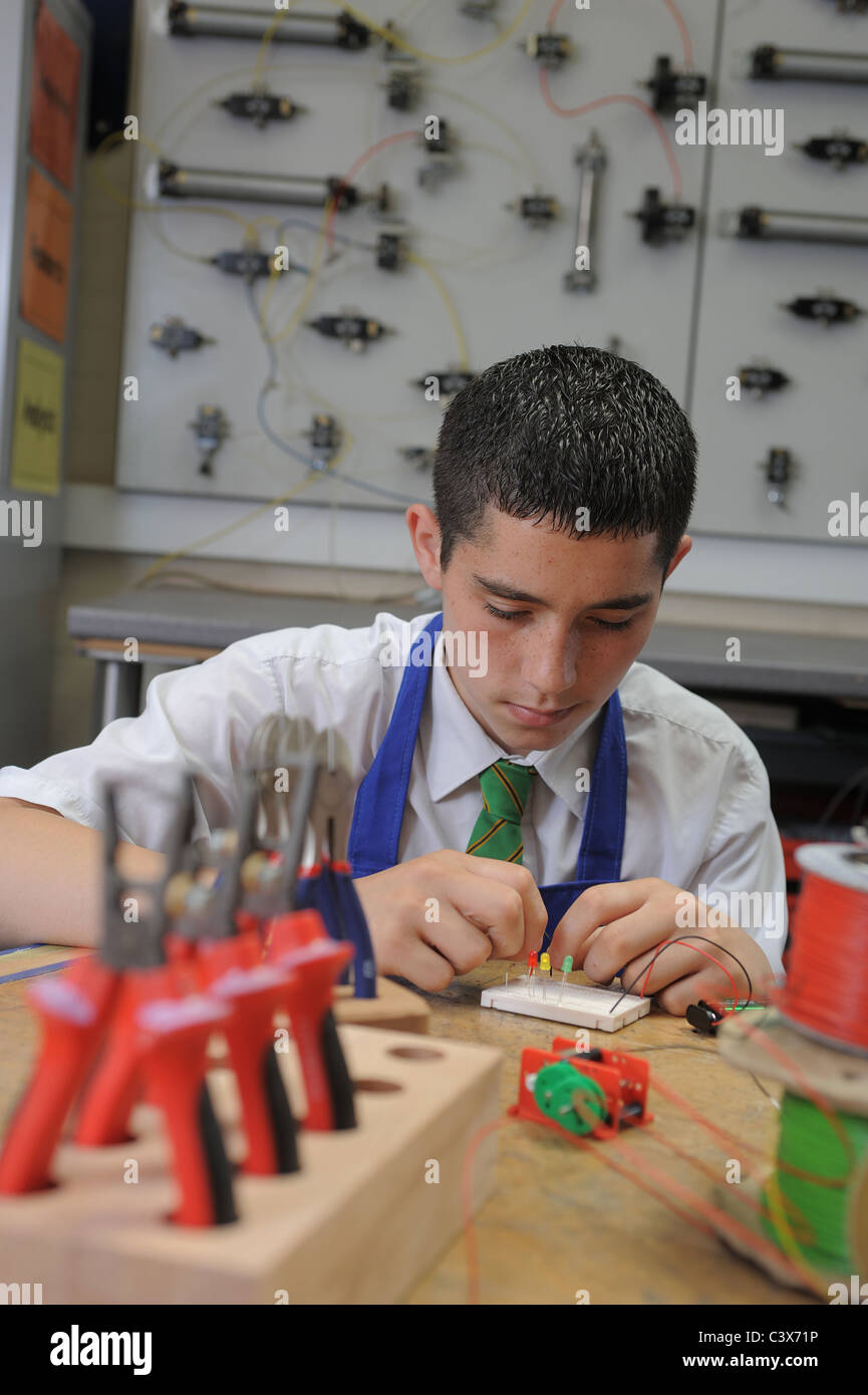 A boy during a GCSE lesson learning about practical electronics and ...