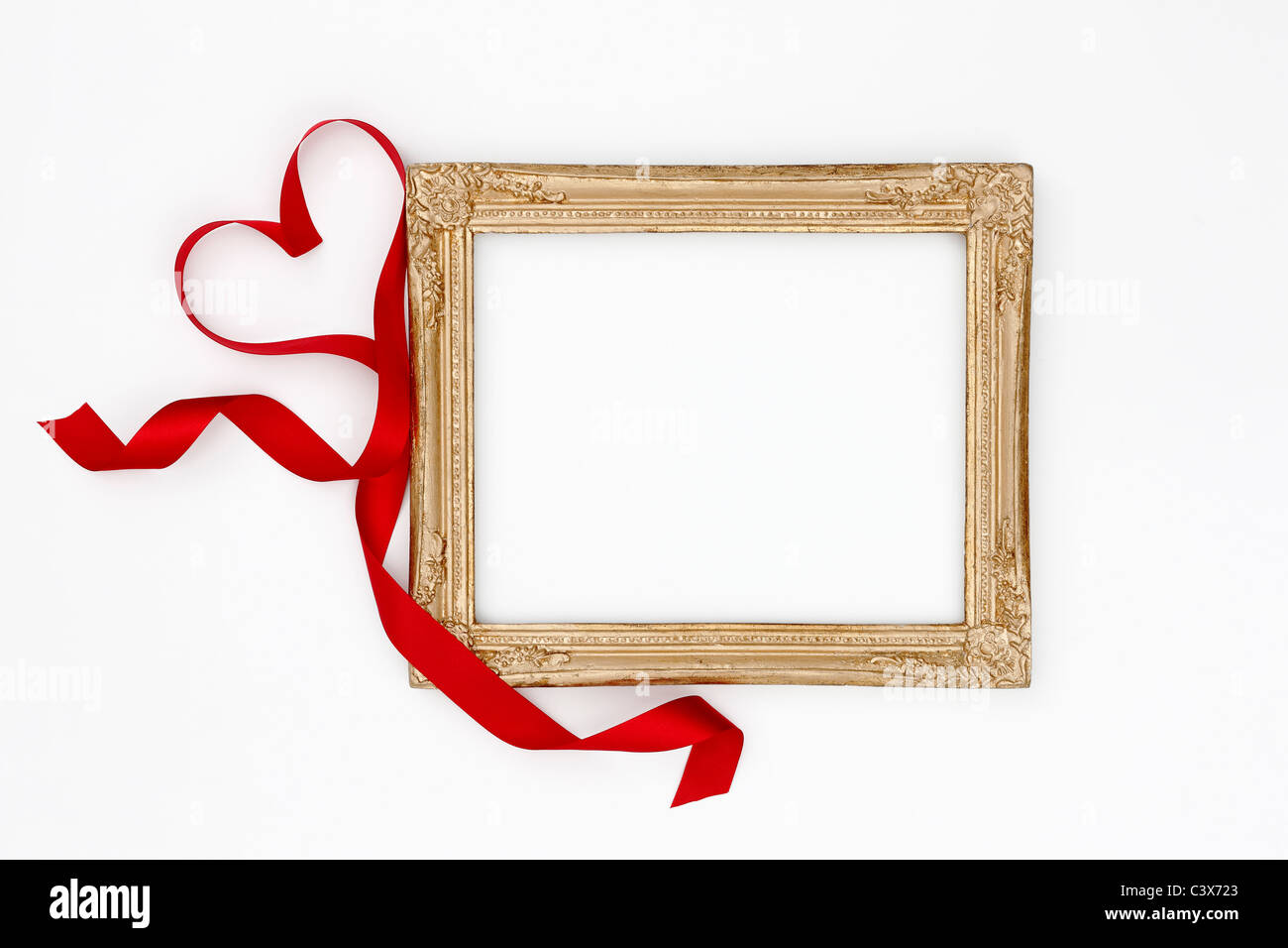 Gold picture frame and red ribbon Stock Photo