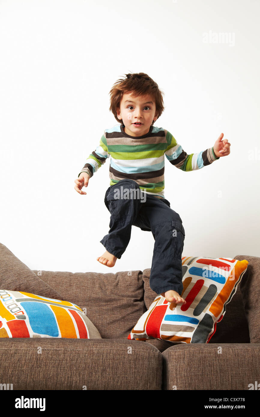 Boy jumping on sofa Stock Photo Alamy