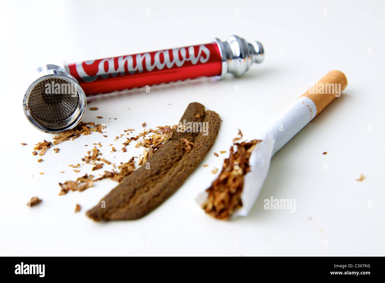 Moroccan hashish or hashish, a cigarette, tobacco and a smoking pipe Stock Photo