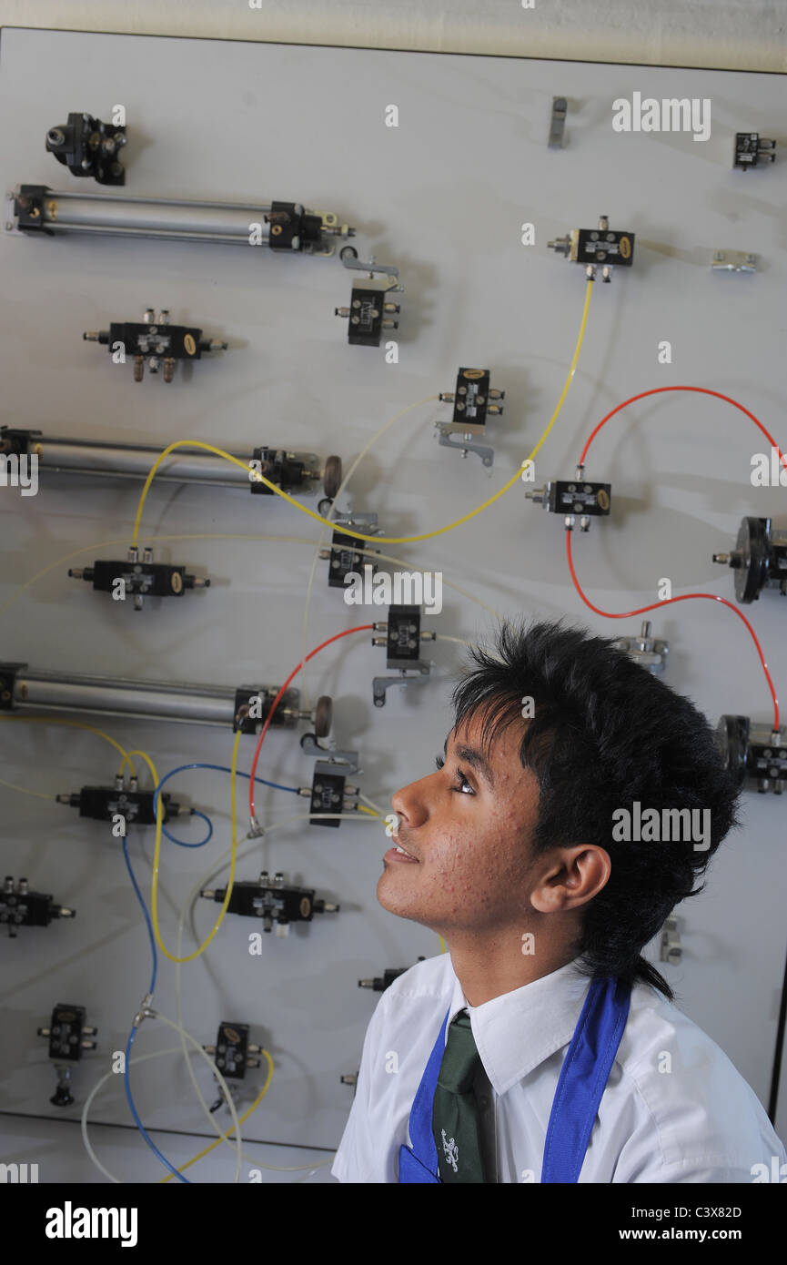 A school boy learning about electronics in a design technology GCSE lesson in a classroom Stock