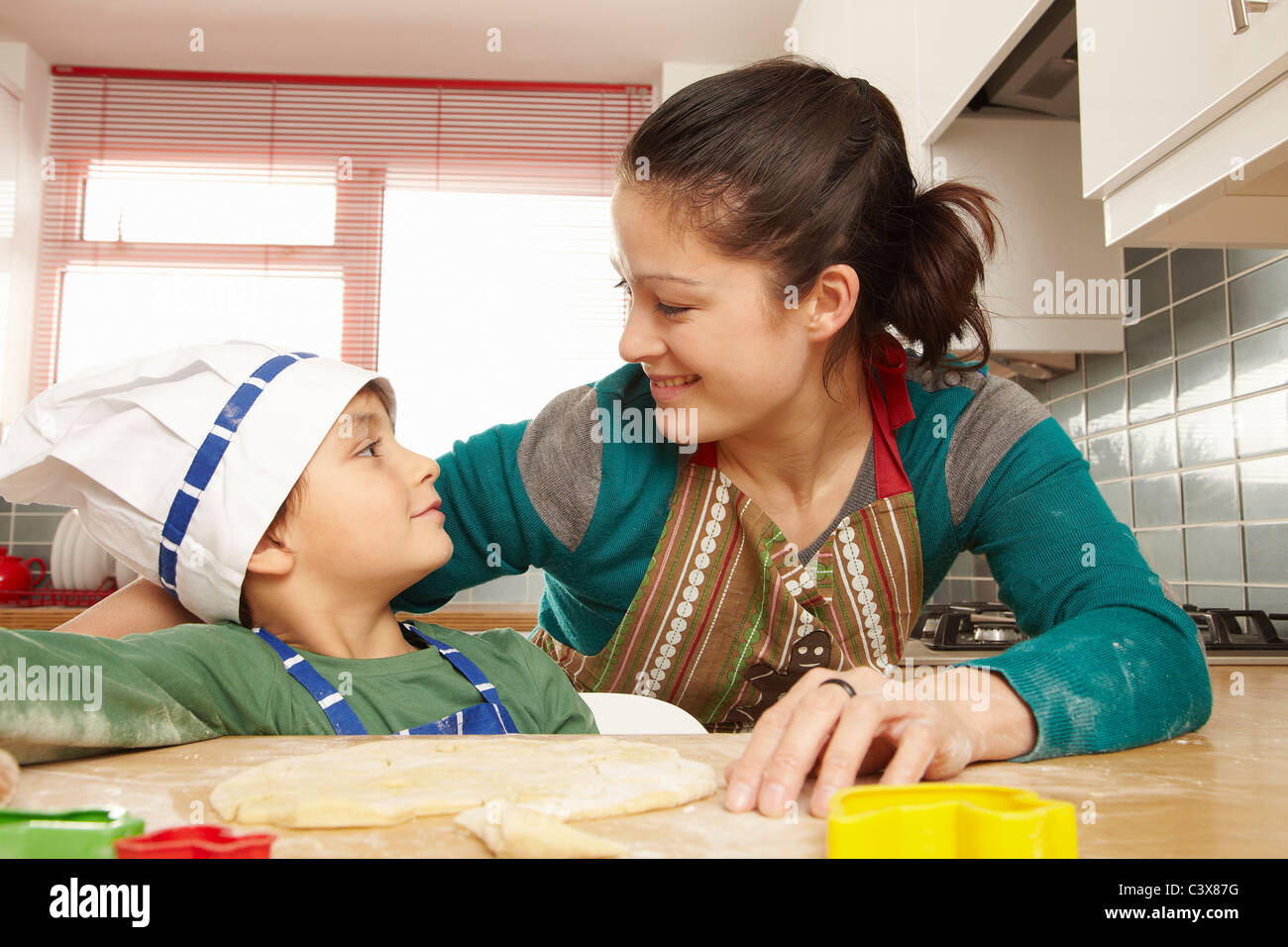 Mother and son having fun in kitchen Stock Photo
