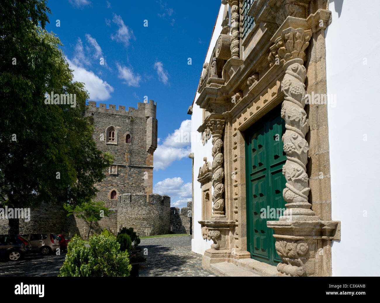 Portugal, Braganca, baroque doorway of the igreja da Santa Maria church, with the castle in the background Stock Photo