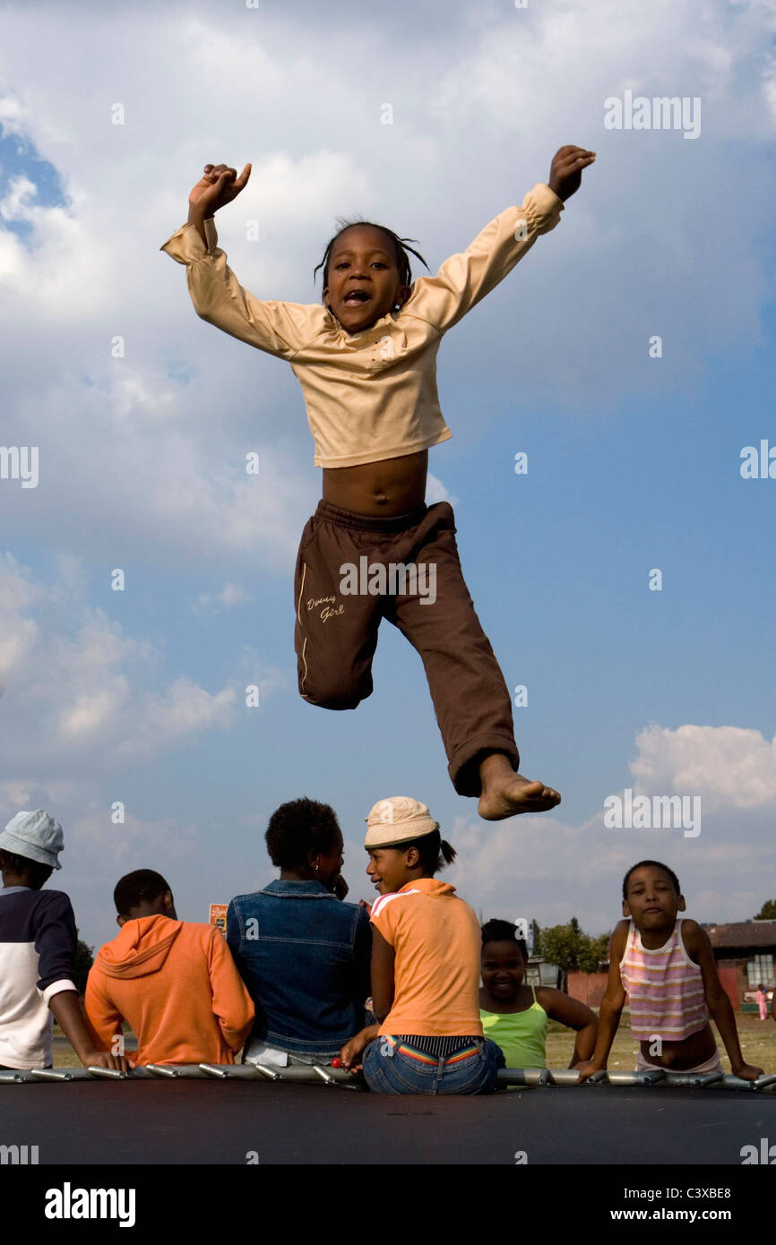 South Africa, Johannesburg, Soweto, Children jumping on trampoline. Stock Photo