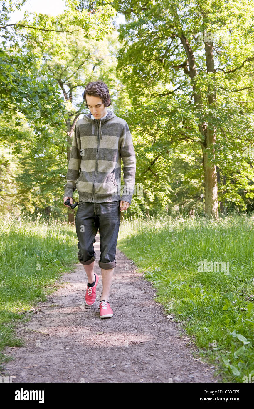 Young man walking in the woods Stock Photo