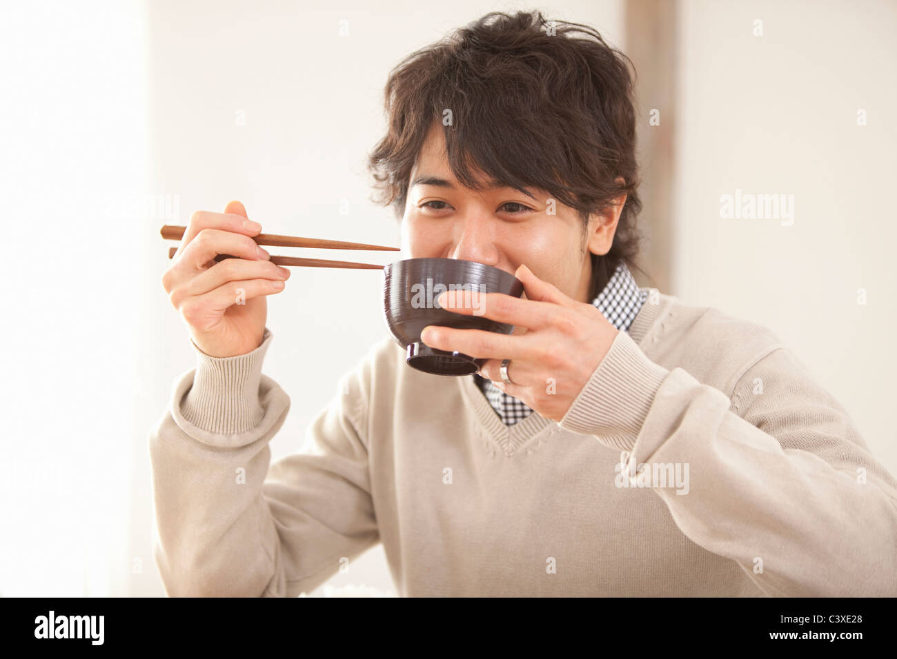 Young Man Eating Stock Photo