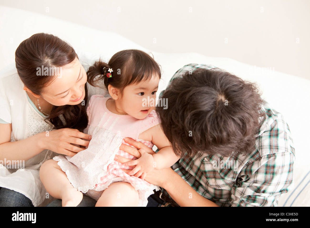 Baby Girl and Parents Stock Photo