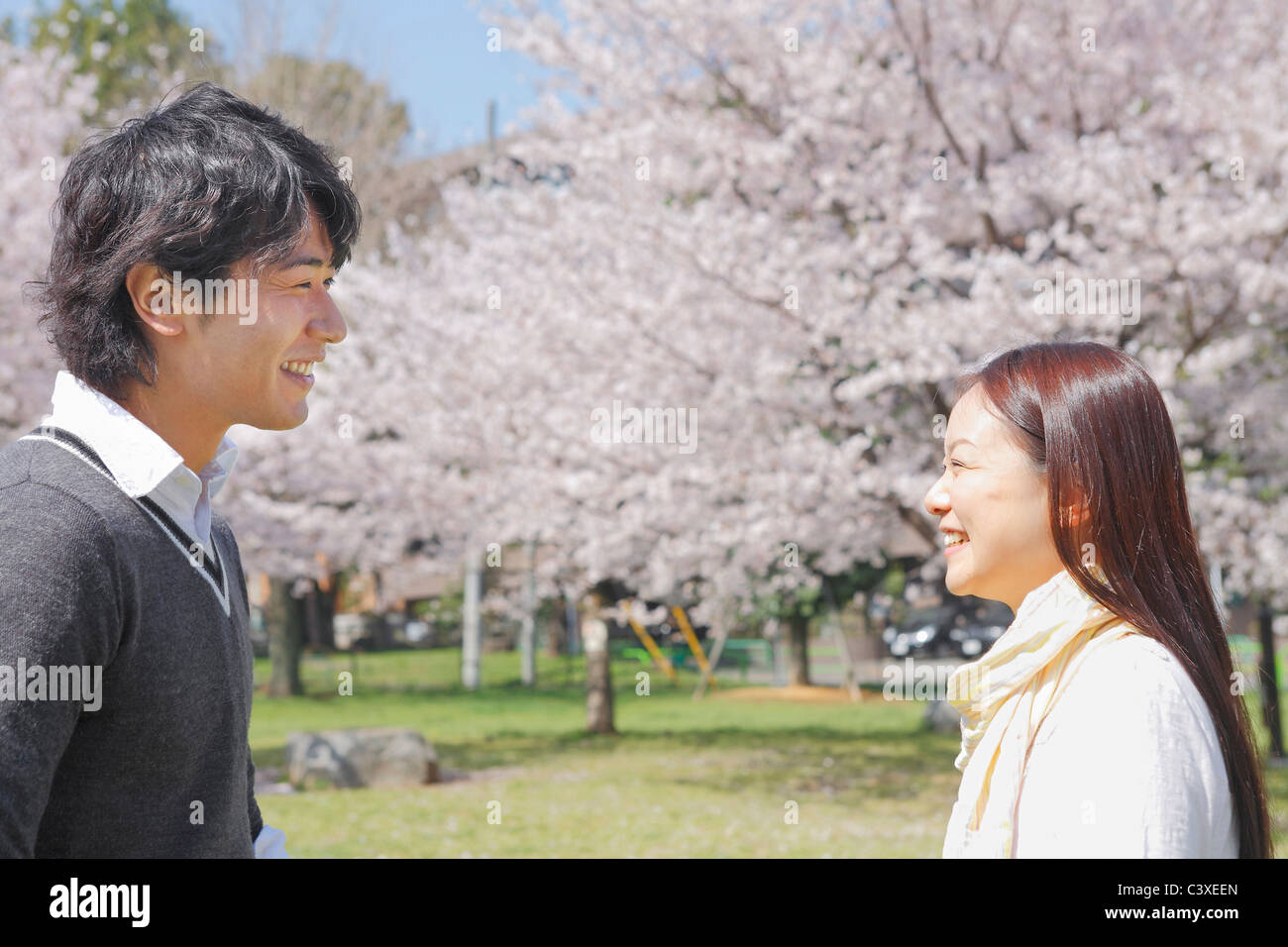 Young Couple in Park Stock Photo - Alamy