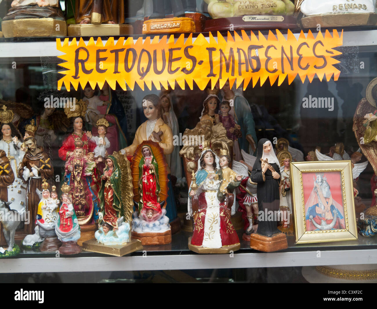 religious souvenirs on display in window, Quito, Ecuador Stock Photo